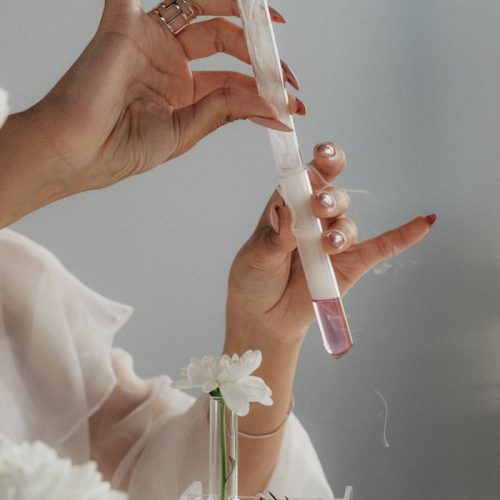 pexels-photo-10182665 Woman with Manicure Holding Test Tubes, and White Flowers in the Glass